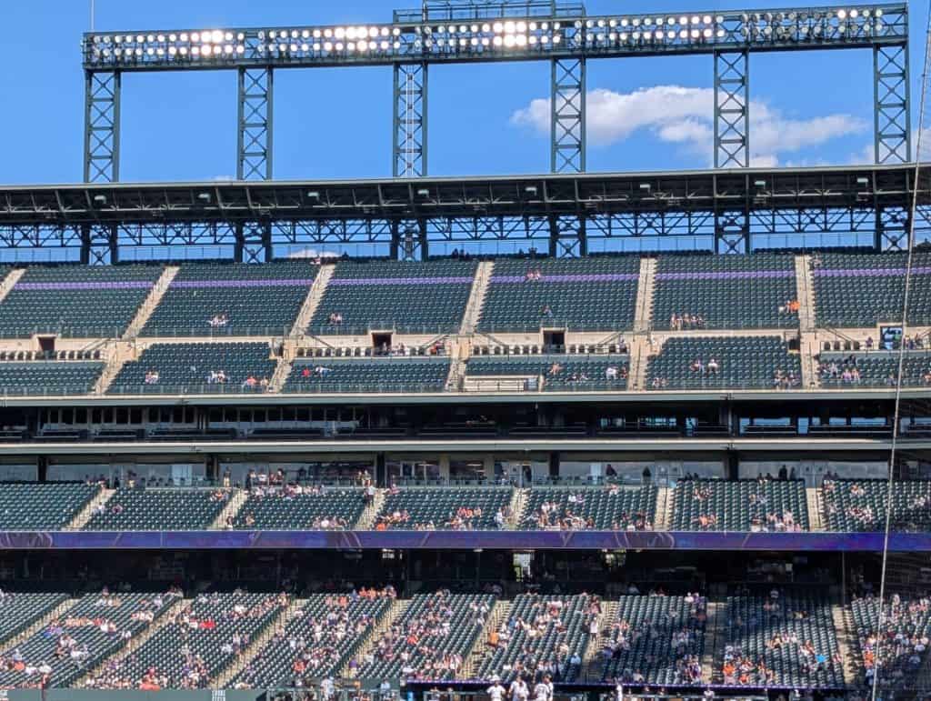 Picture taken from left-field, that shows the purple row of seats that are on the first base side of Coors Field